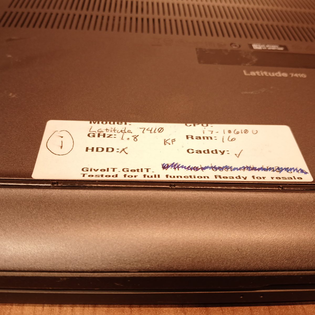 Dell Latitude 7410 bottom label close-up showing model and CPU notes