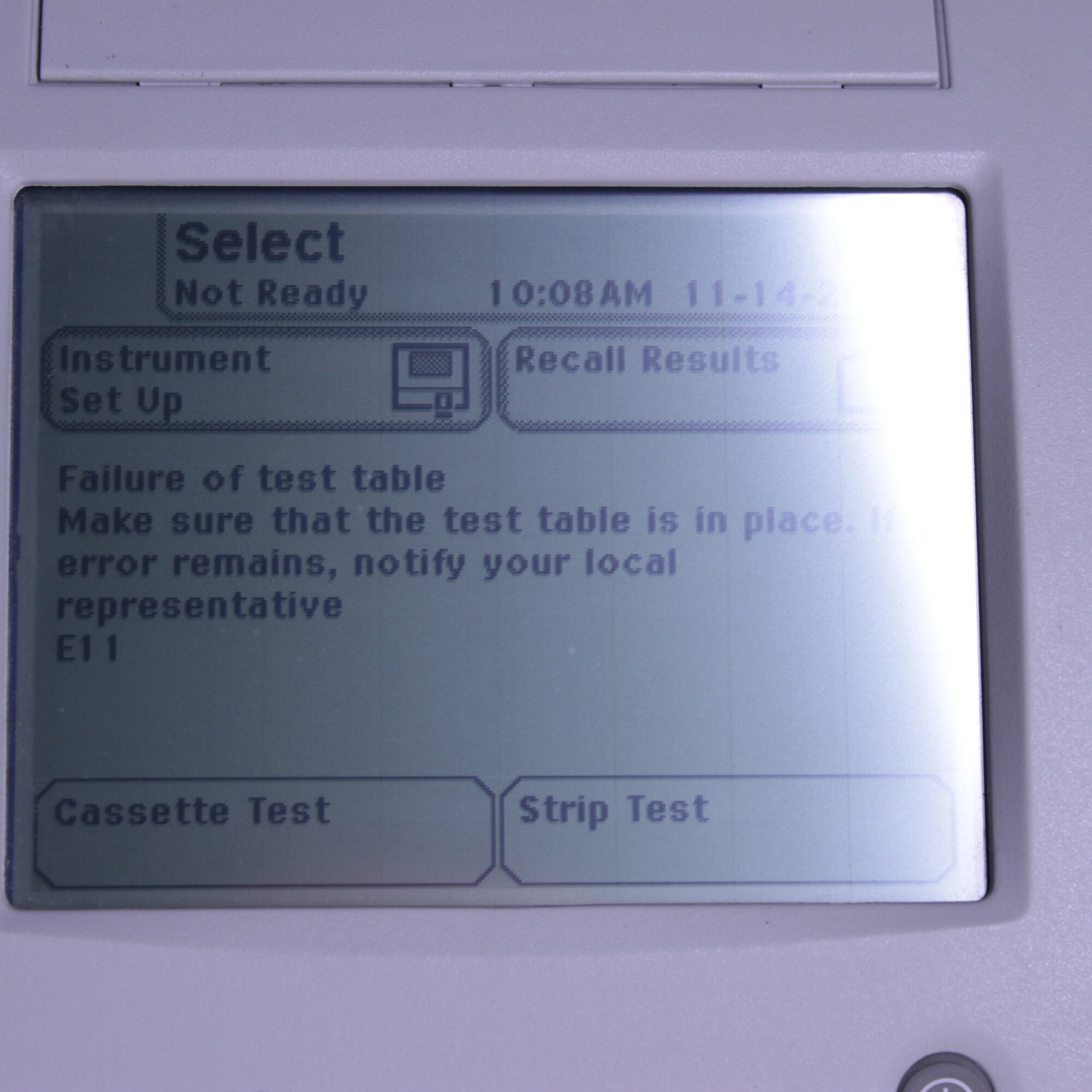 Close-up of Siemens Clinitek Status+ analyzer LCD screen showing instrument setup menu while unit is powered on