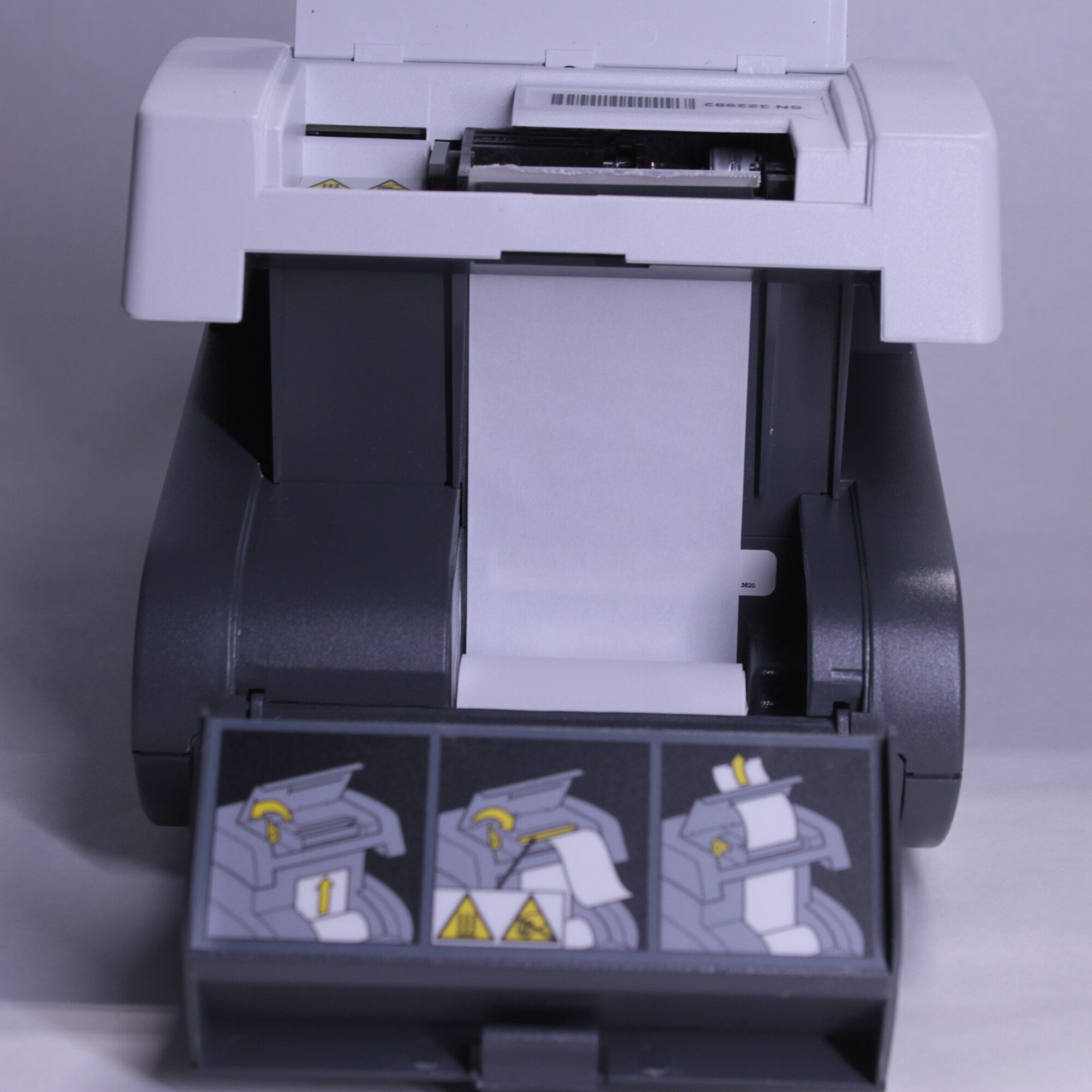 Back of Siemens Clinitek Status+ analyzer with printer door open and paper path exposed for loading