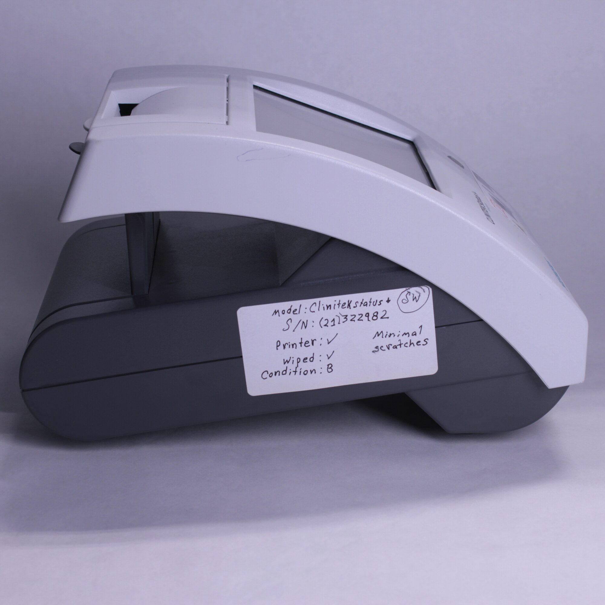Right side view of Siemens Clinitek Status+ analyzer showing condition tag indicating minimal scratches and Grade B rating
