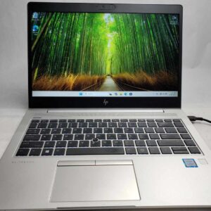 HP EliteBook 840 G5 open showing Windows 11 desktop and keyboard