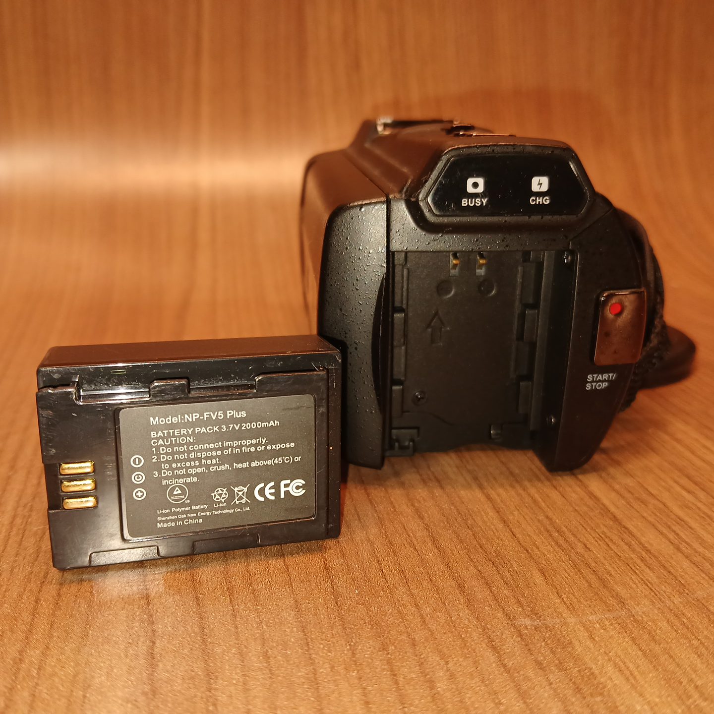 HDV-514K Plus camcorder battery compartment open with NP-FV5 Plus battery