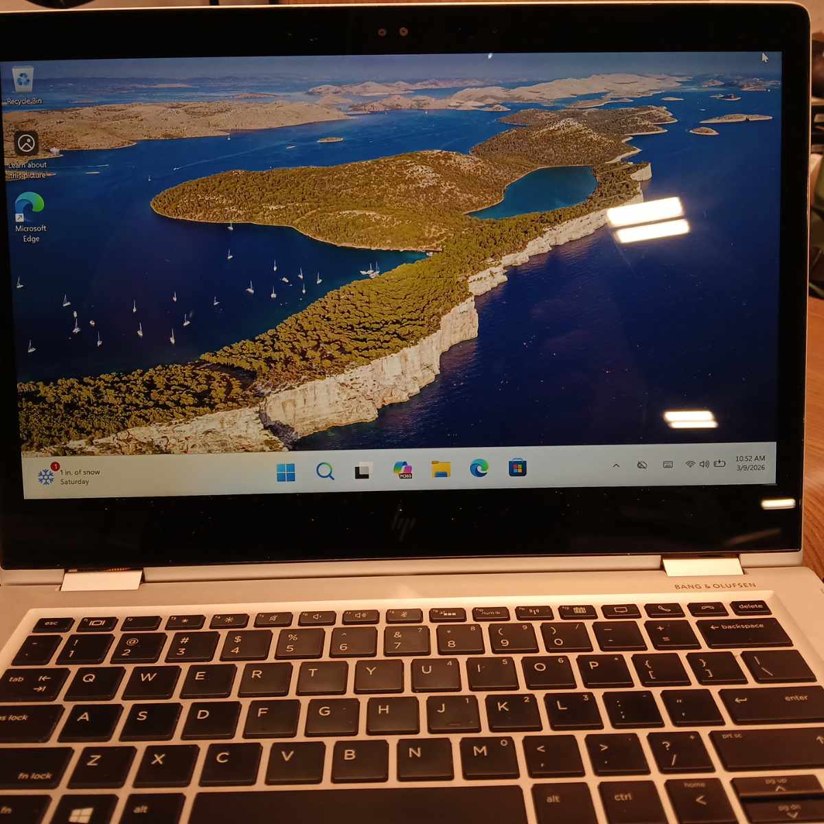 HP EliteBook x360 1030 G2 laptop powered on showing Windows desktop on display