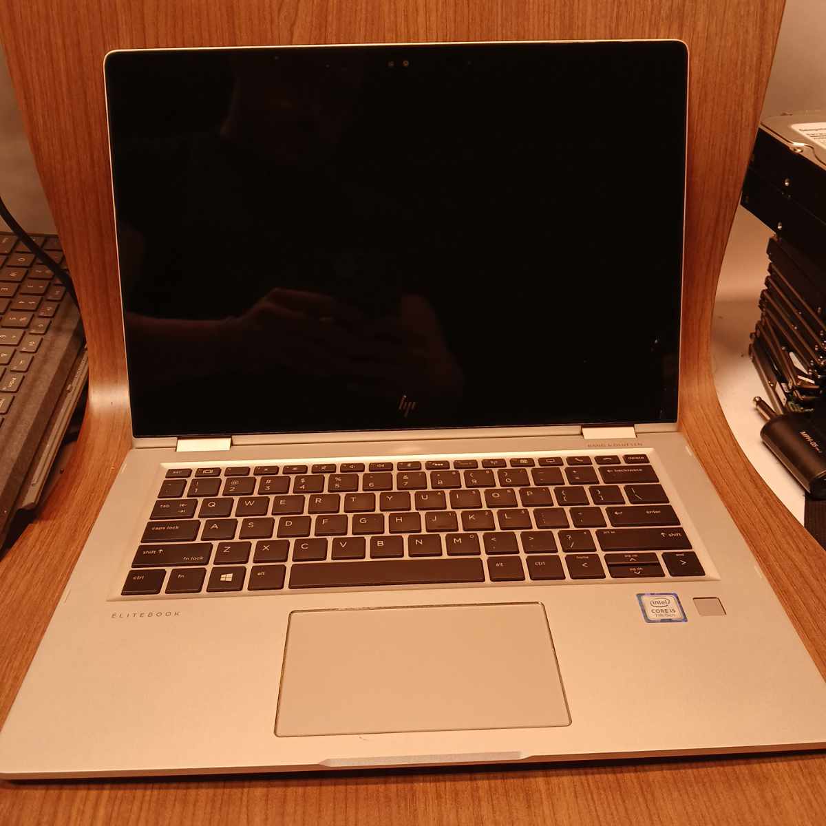 HP EliteBook x360 1030 G2 laptop open with keyboard and blank display