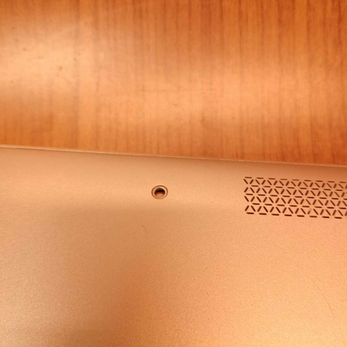 HP EliteBook x360 1030 G2 bottom panel close-up showing screw hole with missing screw and ventilation grille