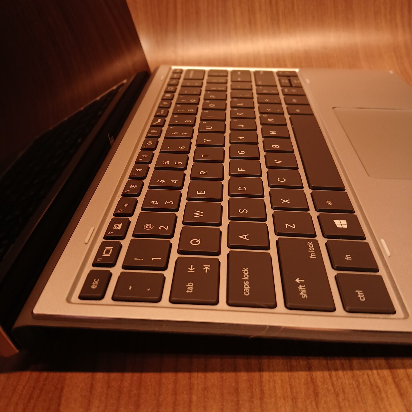 Angled close-up of HP Elite x2 G4 keyboard and side profile on detachable 2-in-1 laptop