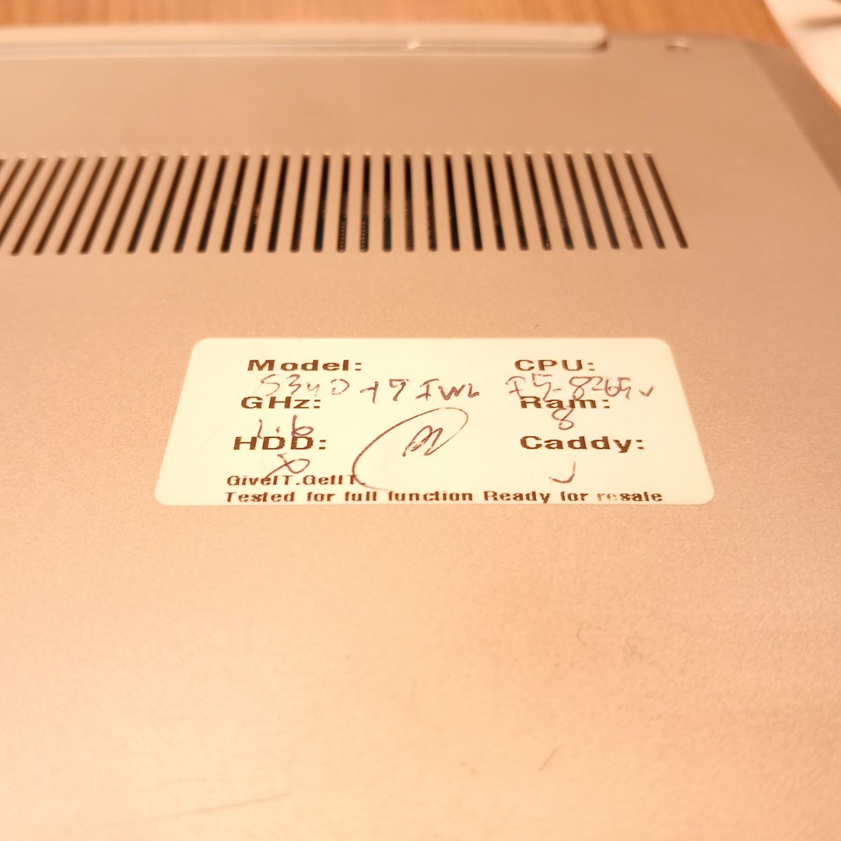 Bottom cover of Lenovo IdeaPad S340-15IWL with inventory label attached
