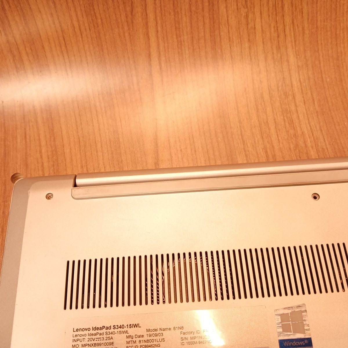 Underside ventilation grille and hinge area on Lenovo IdeaPad S340-15IWL laptop