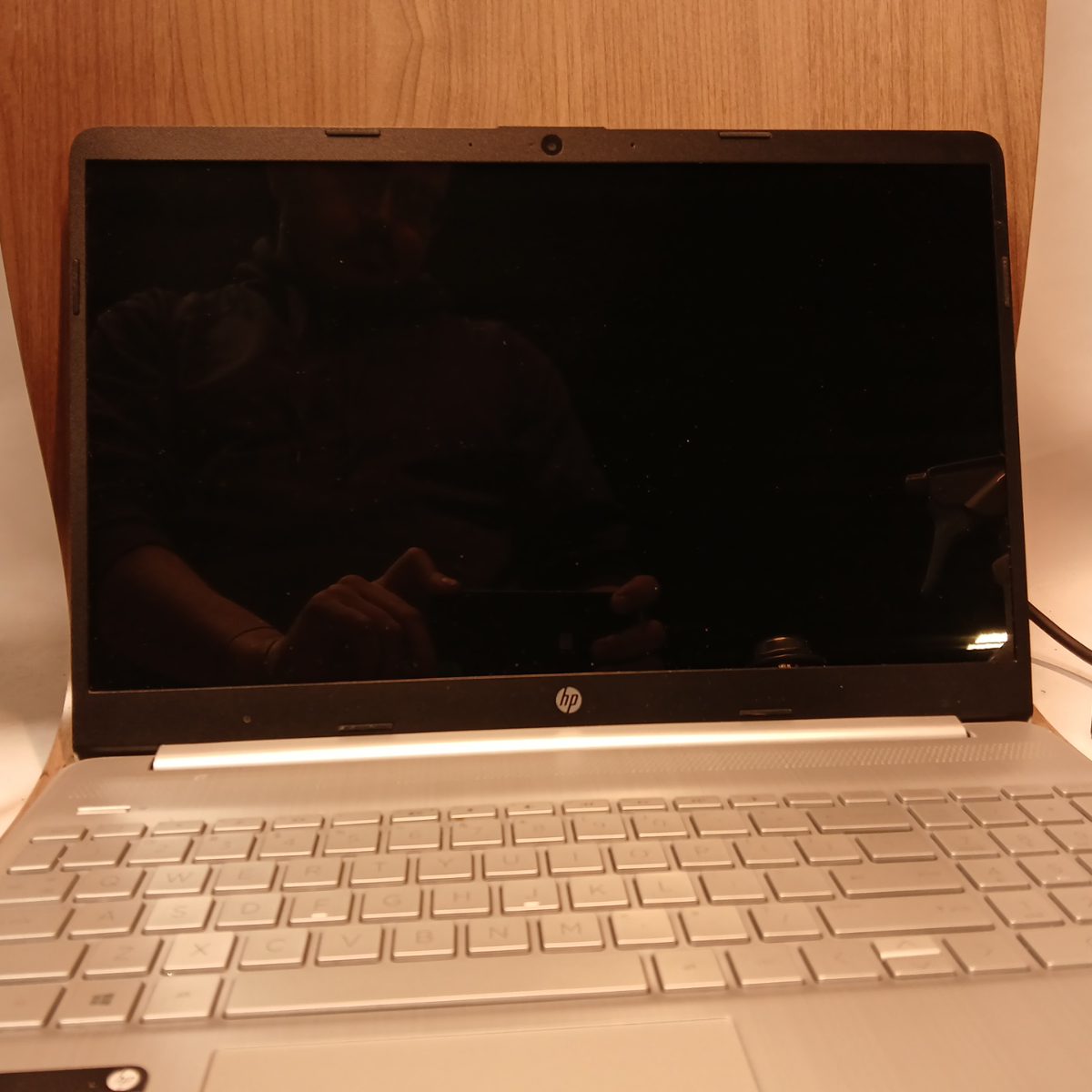 Front view of HP 15-dy2091wm silver laptop with screen off and full keyboard visible