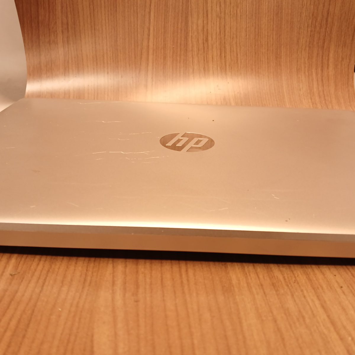 Top lid of HP 15-dy2091wm silver laptop with HP logo and visible cosmetic wear