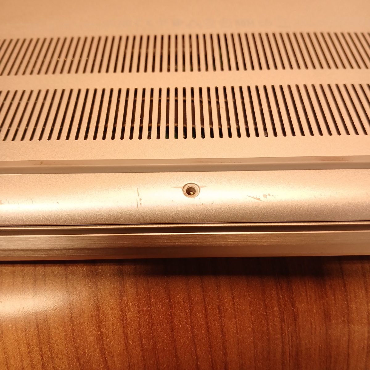 Close-up of bottom cover screw mount and ventilation grille on Dell Inspiron 15 7501