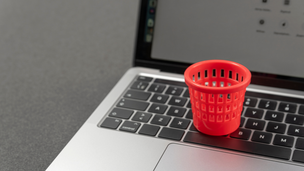 wastebasket sitting on laptopcomputer